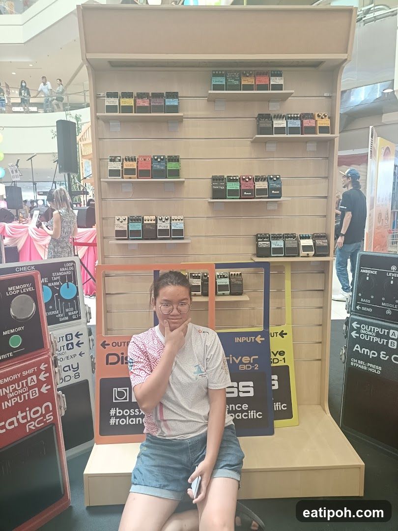 Person at Guitar Effects Display