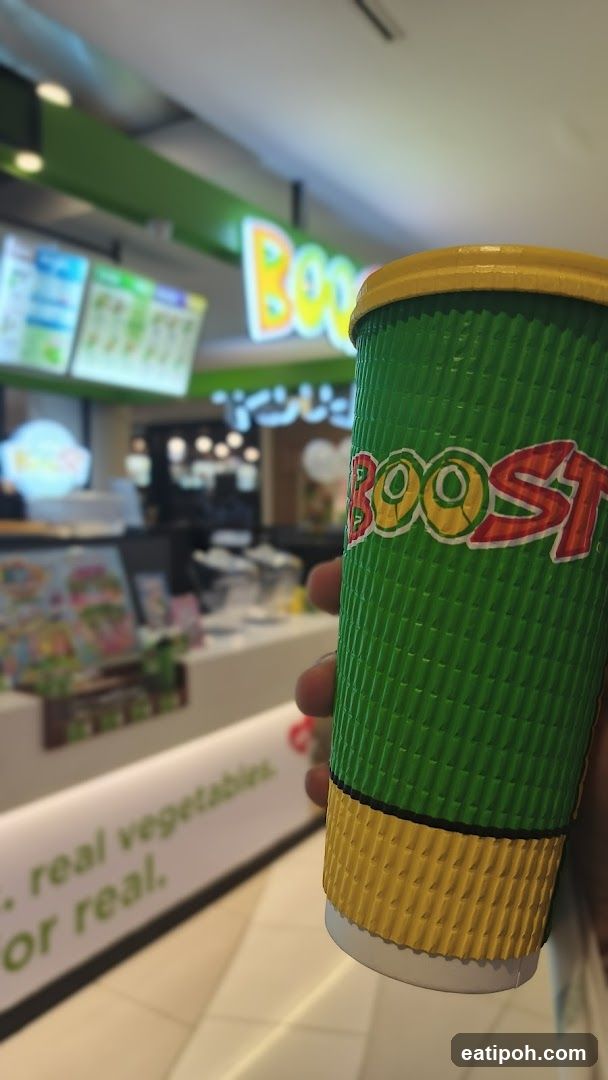 Boost Beverage Cup Held in Hand