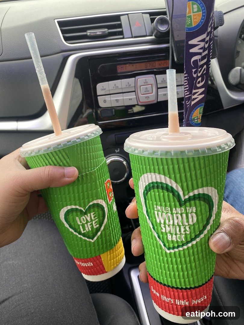 Two green cups held in car