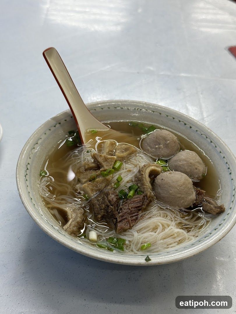 Bowl of noodle soup with meatballs and broth