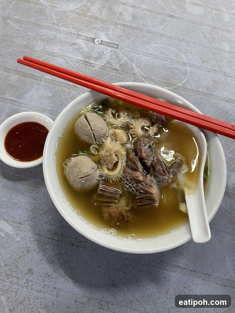 Bowl of Soup with Red Chopsticks