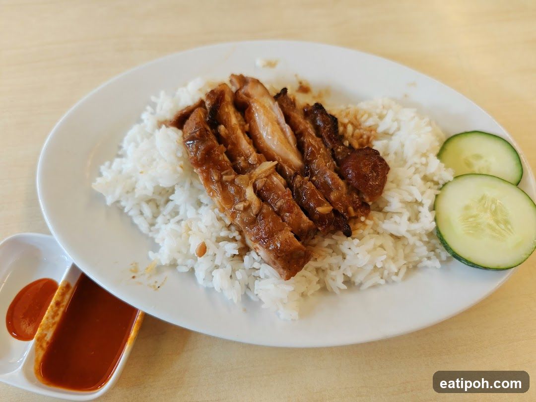 Rice dish with grilled meat and cucumber slices