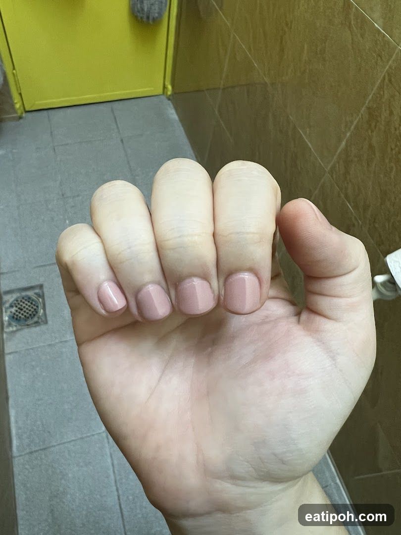 Hand with nails in bathroom