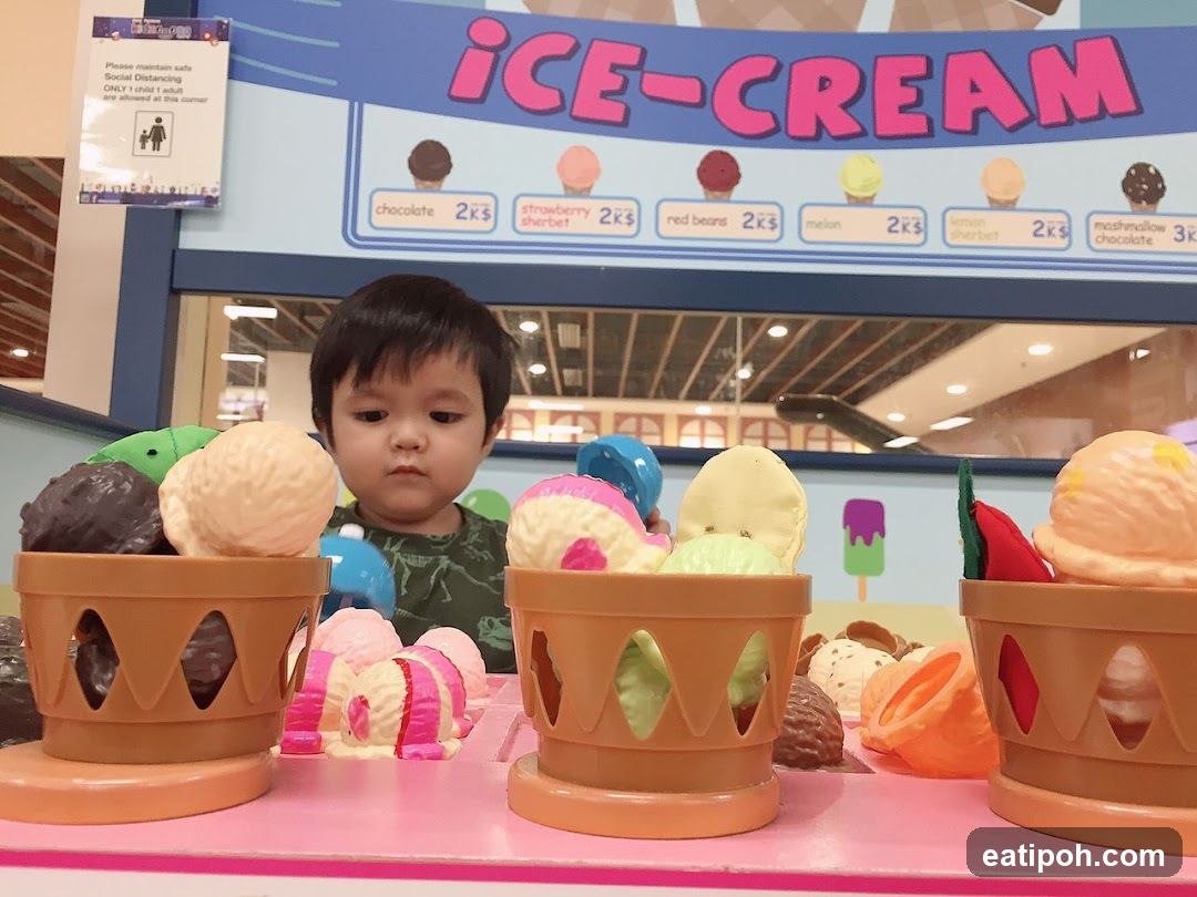 Child at toy ice cream counter