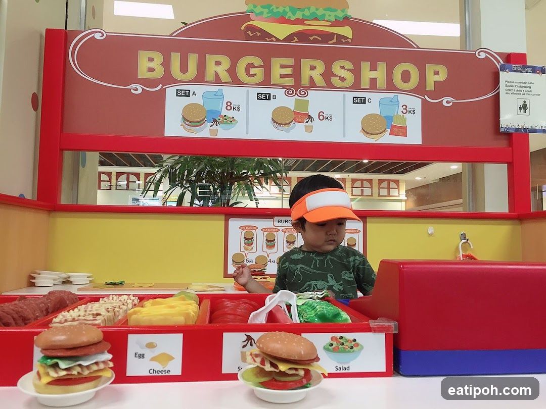 Child playing at a toy burger shop