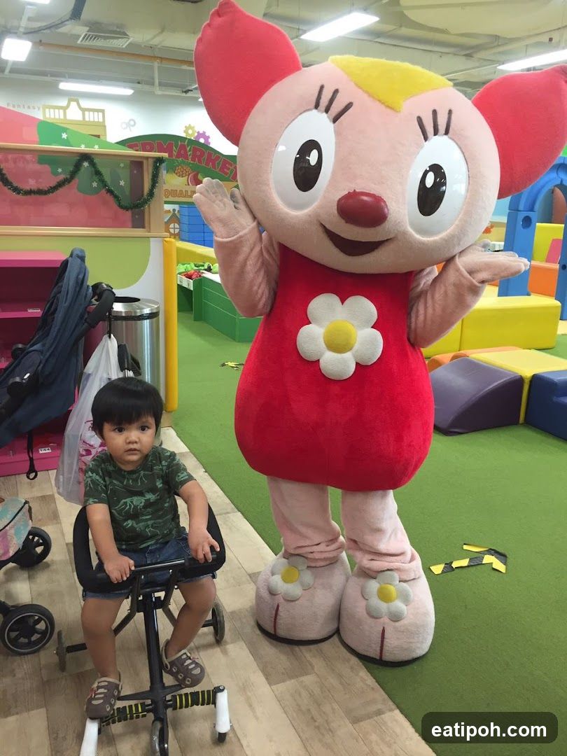 Child and mascot in indoor play area