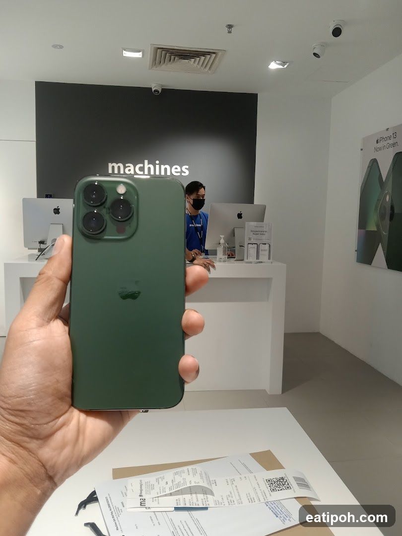 Person holding a green iPhone 13 Pro