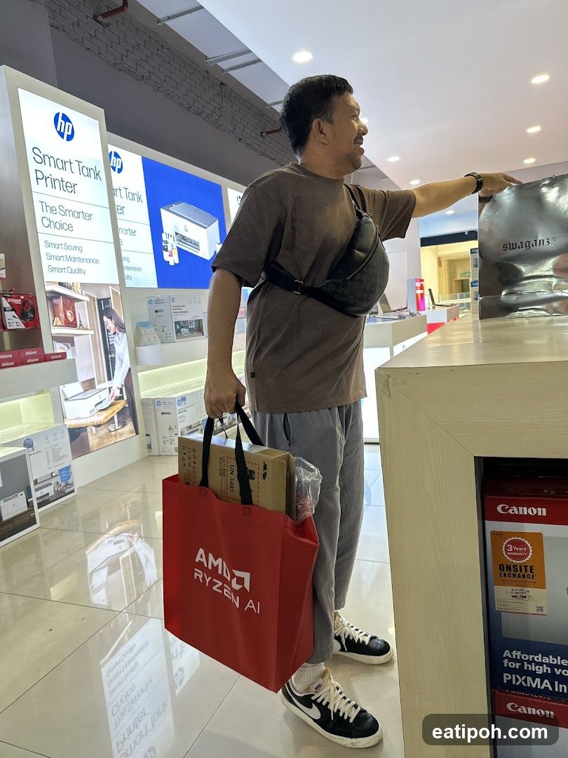 Man with shopping bag in electronics store