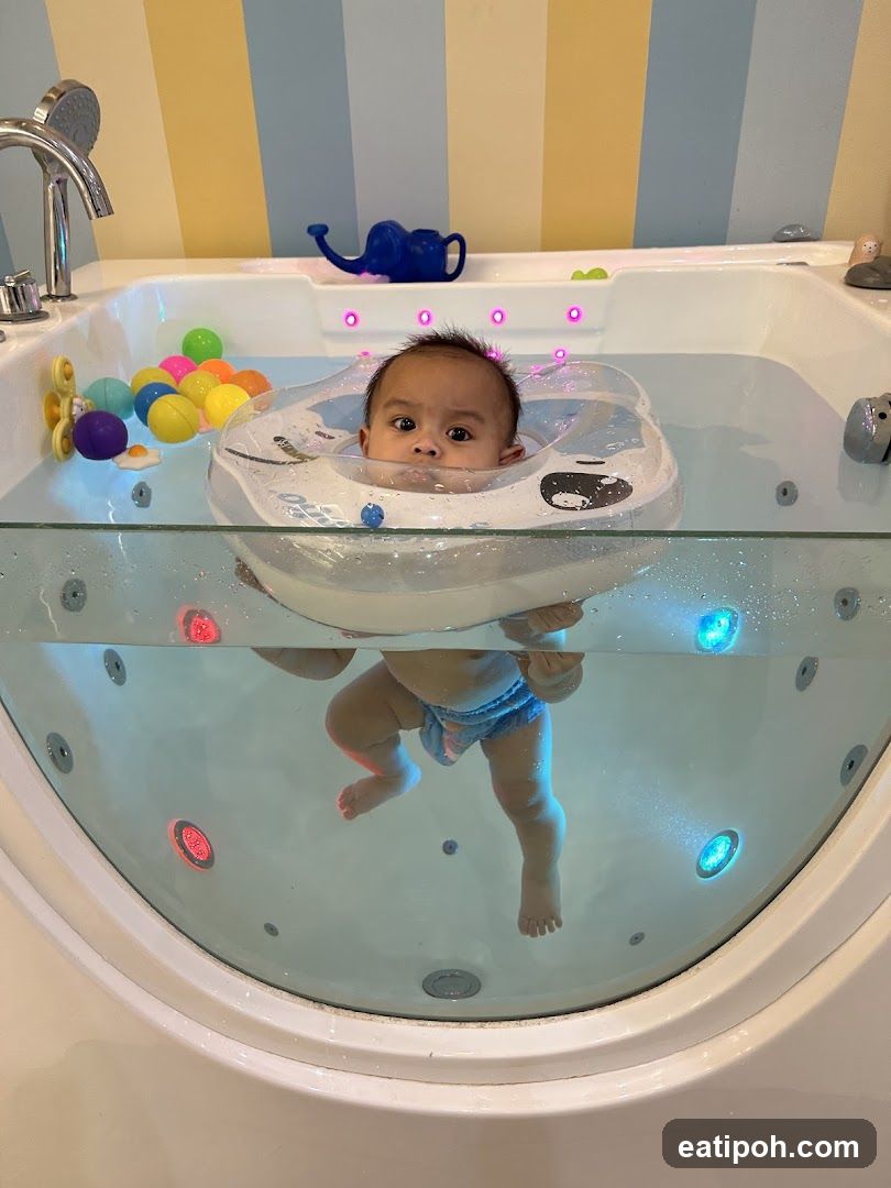 Baby in a bathtub with a float