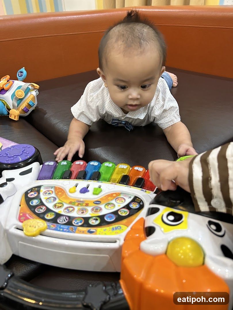 Baby playing with a toy piano
