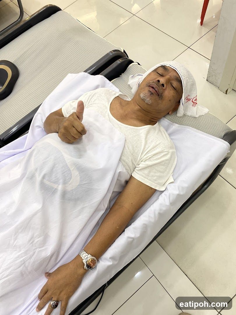 Man giving a thumbs up while lying down