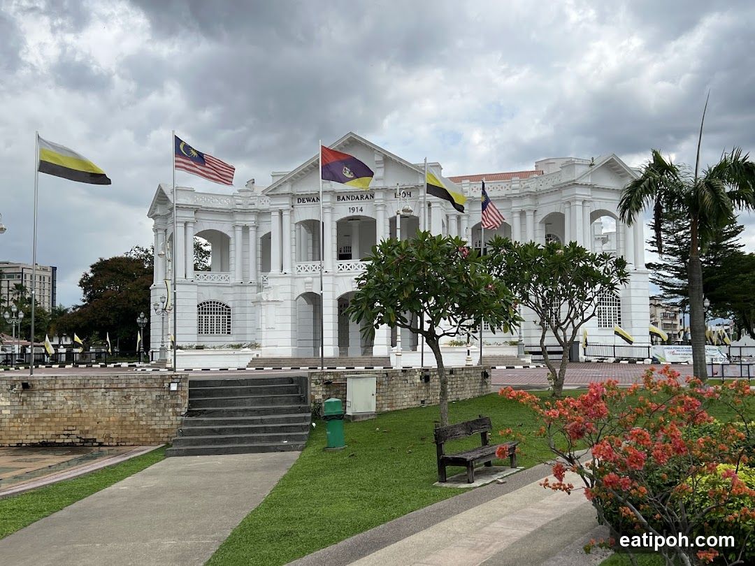 White Colonial Building with Flags