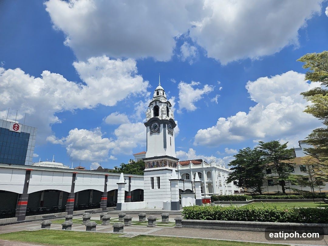 Clock Tower and Buildings Under a Cloudy Sky