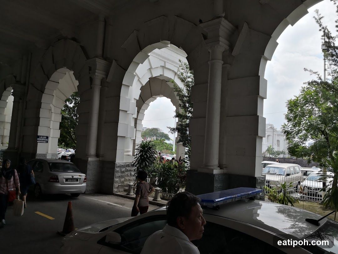 Arched walkway with cars and people