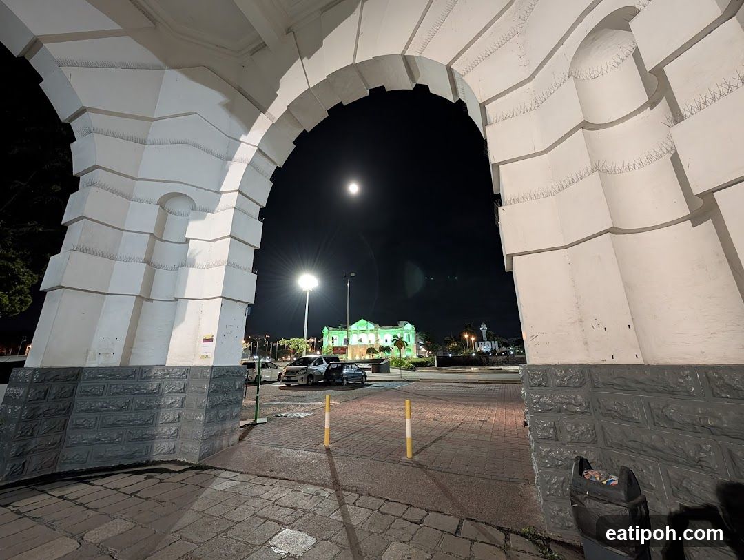 Archway View of Illuminated Building at Night