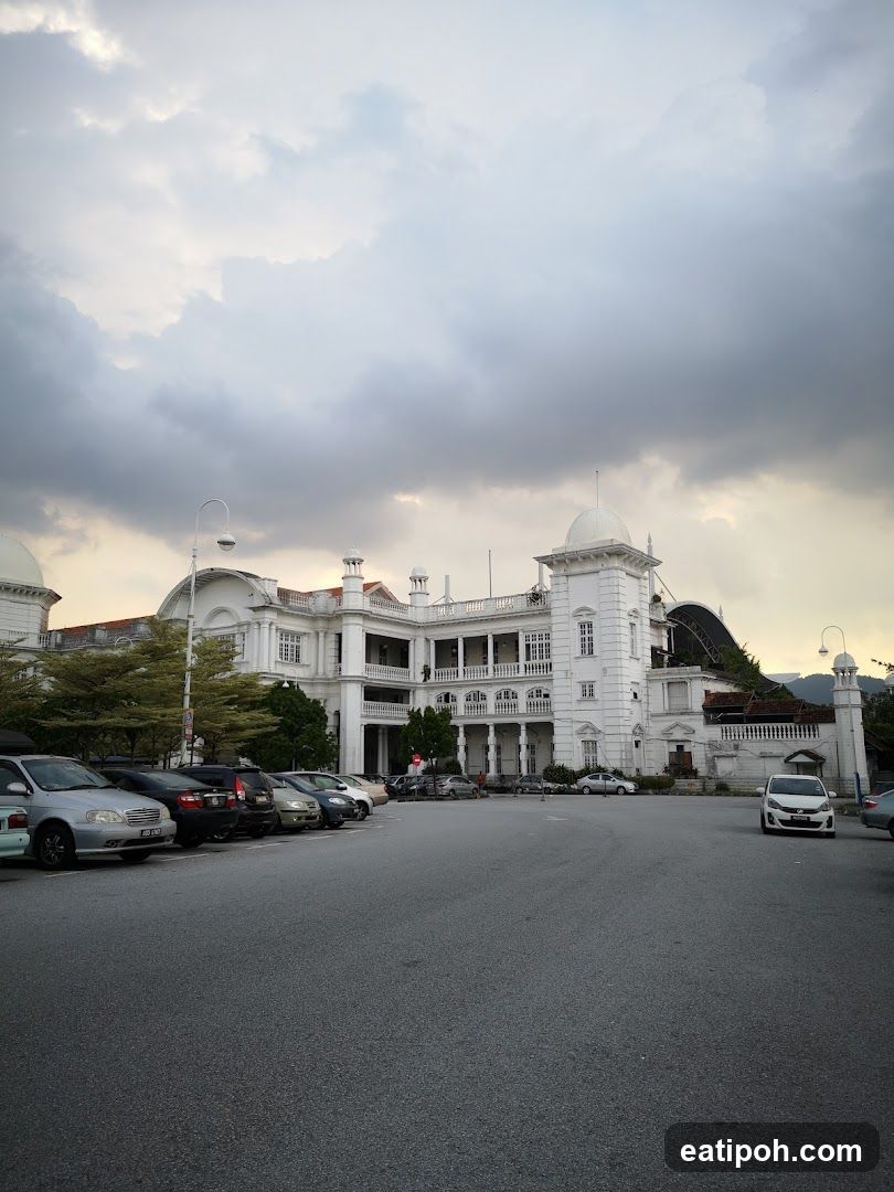 White Building with Cars in Parking Lot