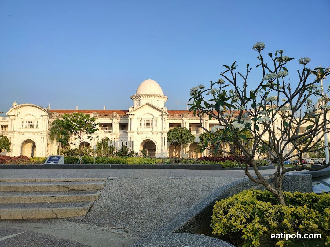 White Building with Dome and Flowering Tree