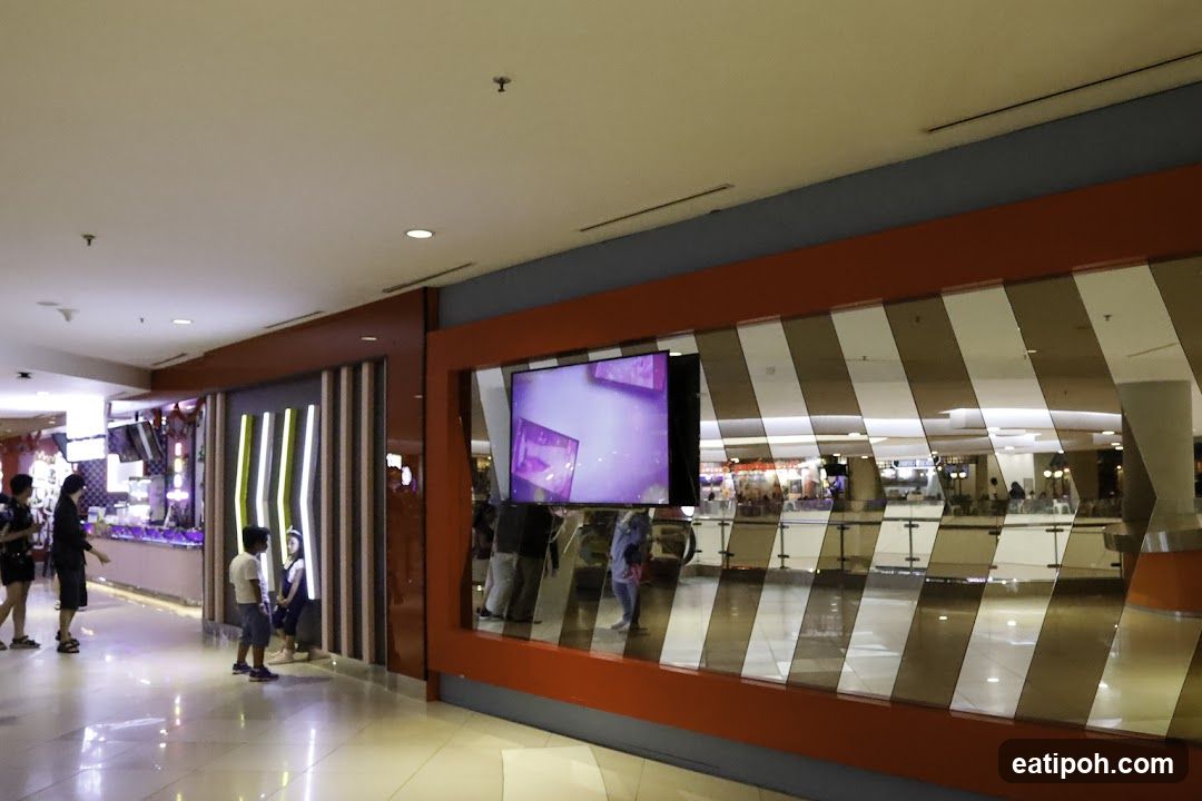 Interior of a shopping mall with a digital screen