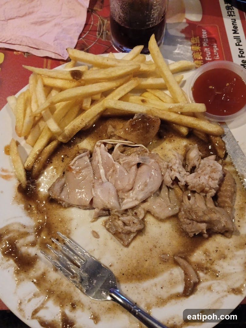 Partially Eaten Meal with Fries and Sauce