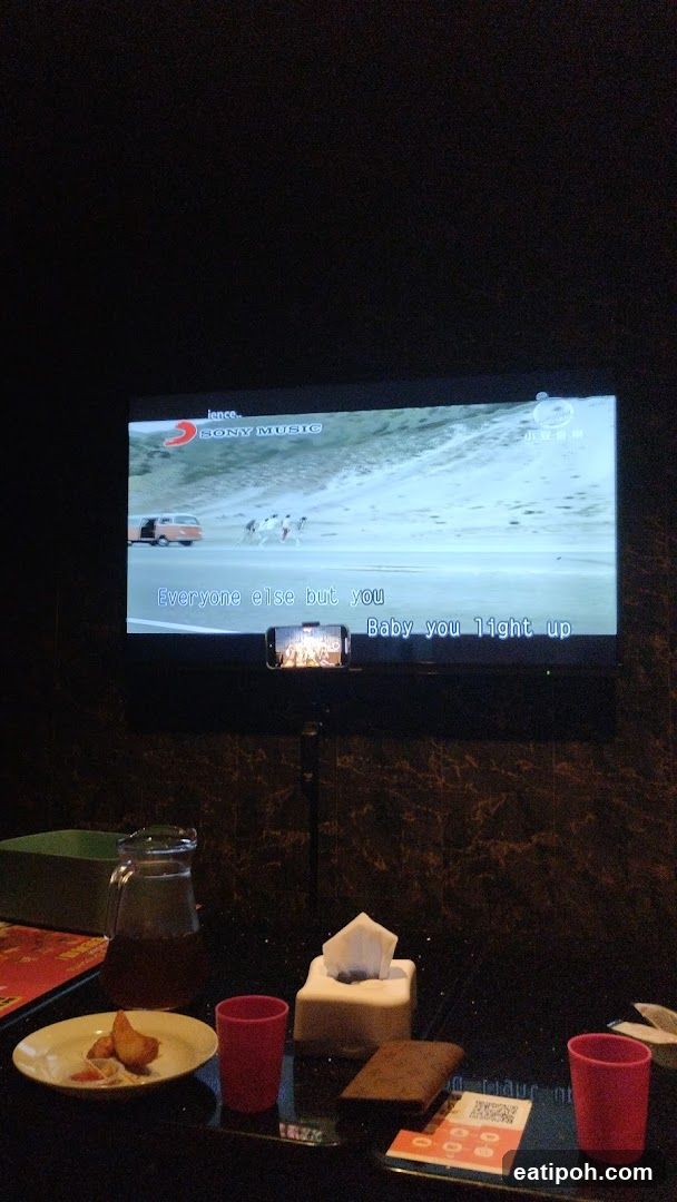 Karaoke screen with lyrics and drinks