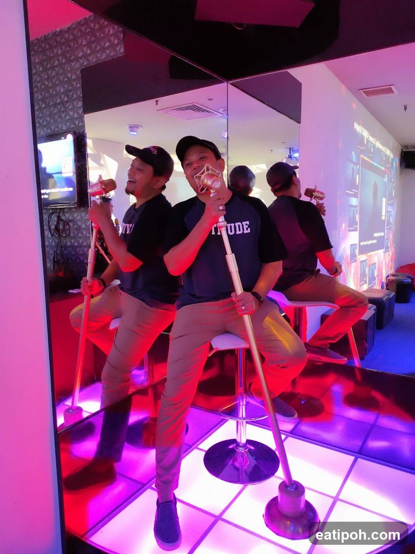 Man singing in a karaoke booth
