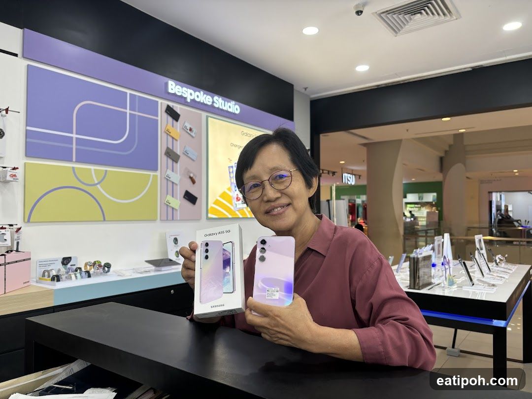 Woman holding a Samsung Galaxy A55 5G phone and box