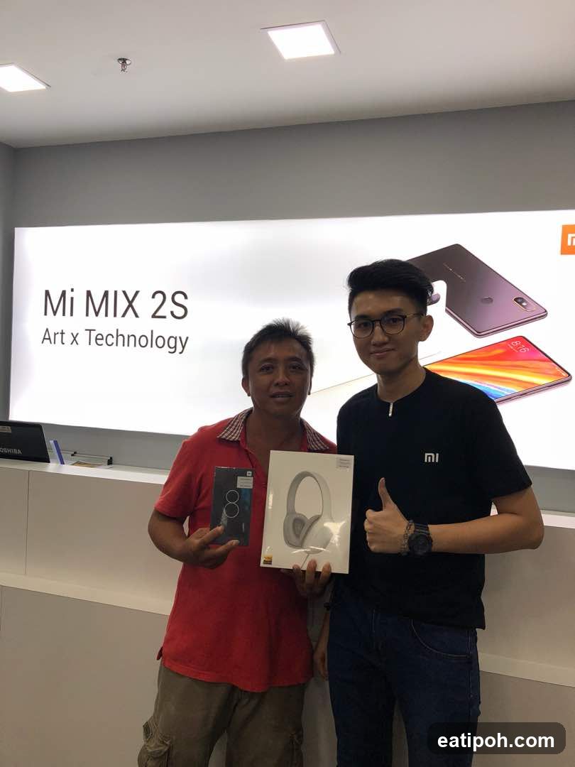 Two men holding products in a store