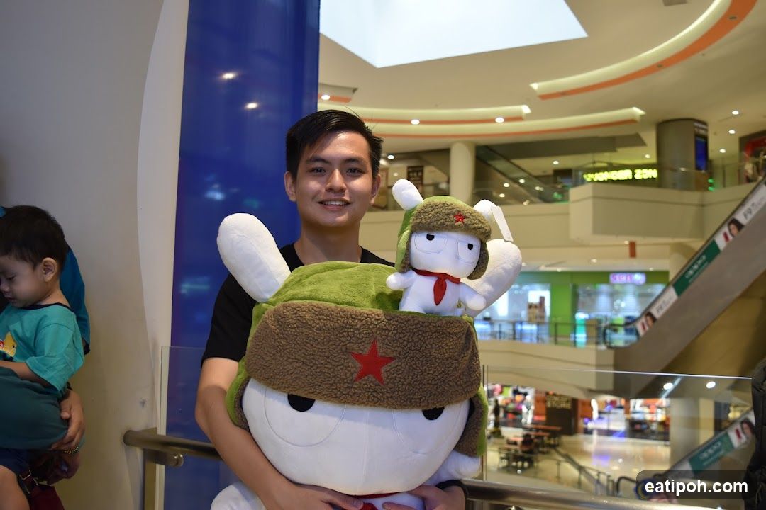 Man holding large stuffed toys