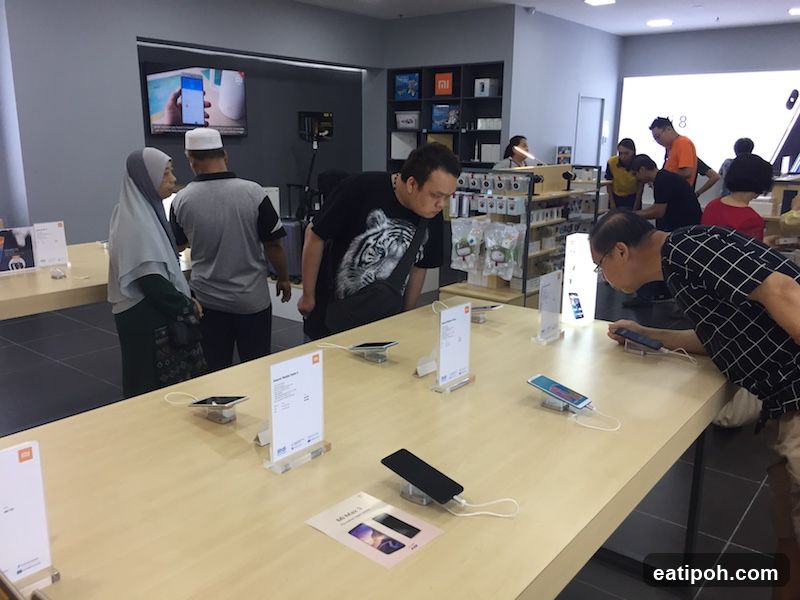 Customers browsing smartphones in a store