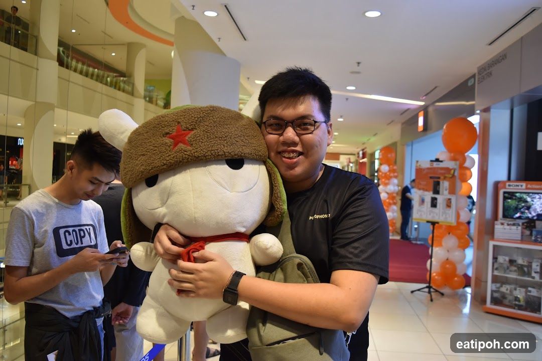 Man holding a large stuffed toy