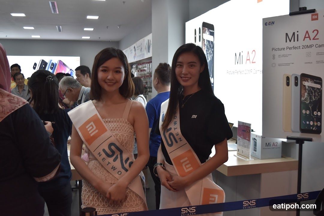 Two women in sashes in a store