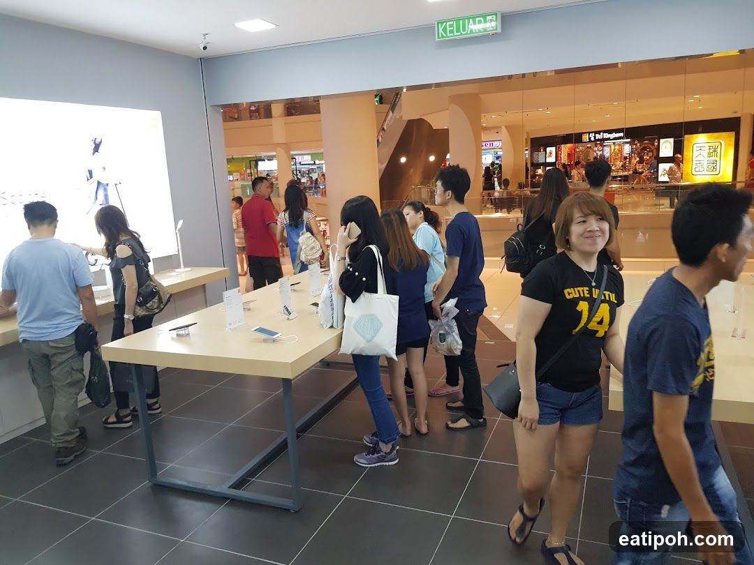 People browsing electronics in a store