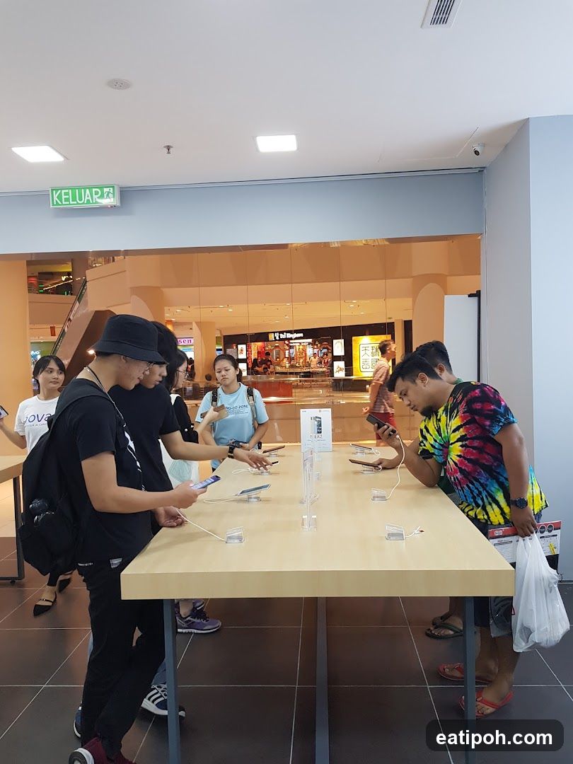 Customers browsing phones in a store