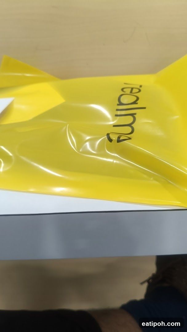 Yellow shopping bag with Realme logo