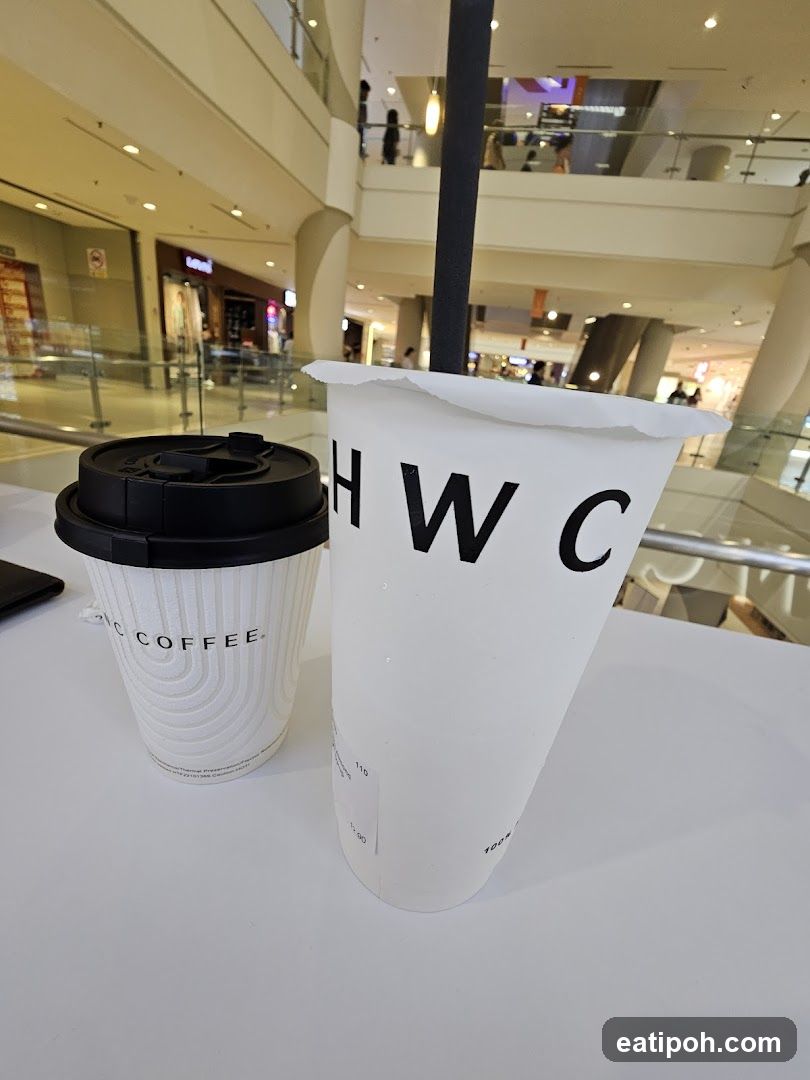 Two drinks on a table in a mall