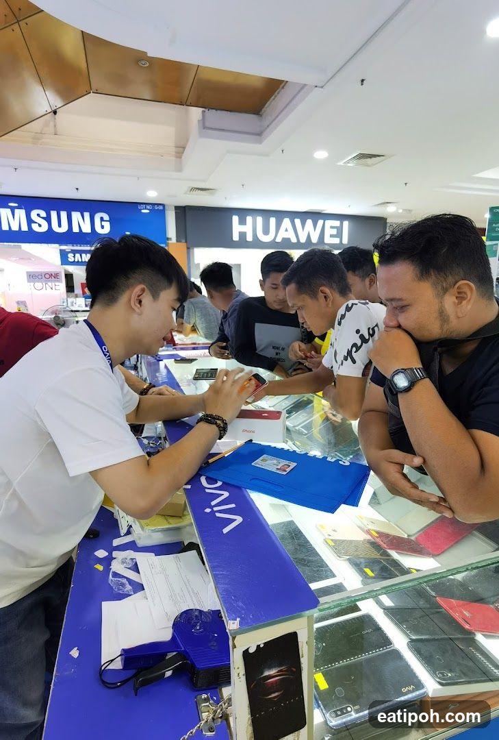 Customers browsing phones at a retail store