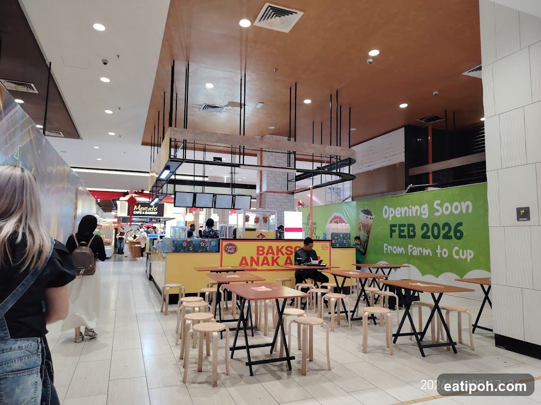 Food stall with seating and opening soon banner