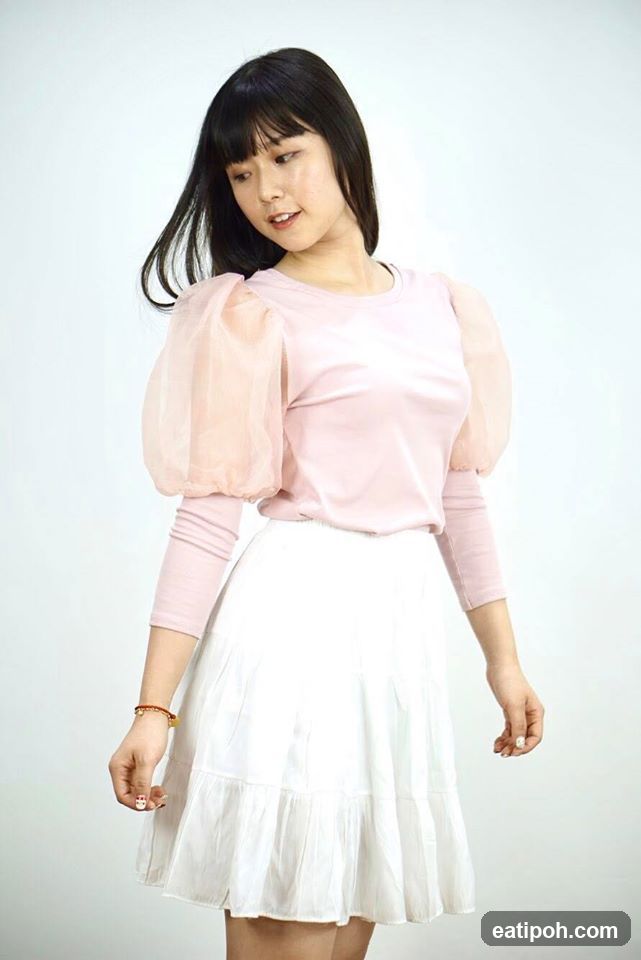 Woman in pink top and white skirt