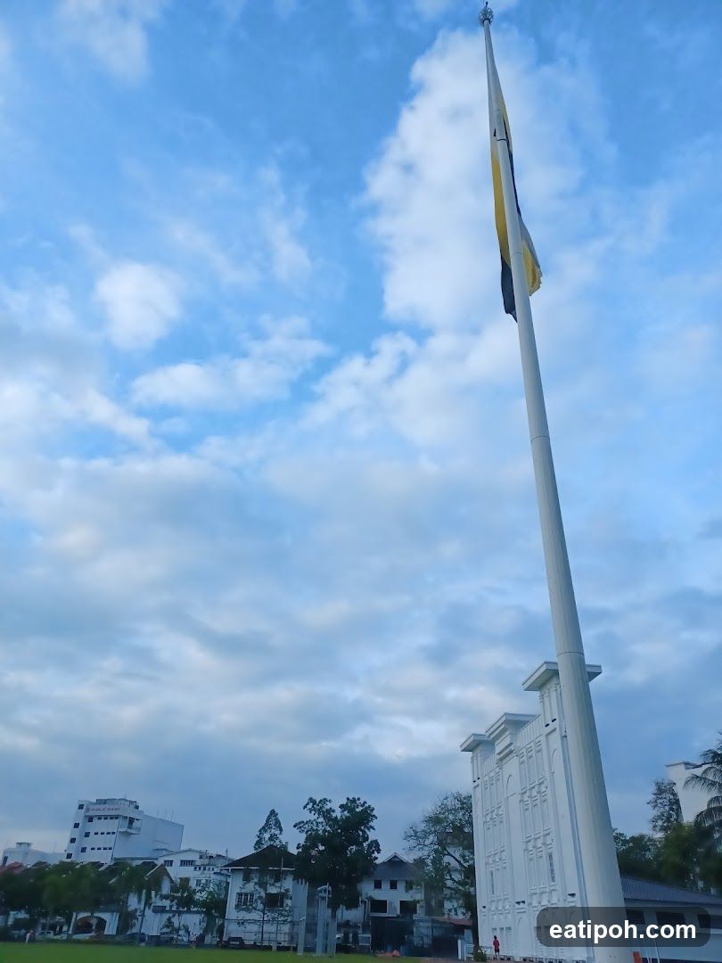 Tall flagpole against a cloudy sky