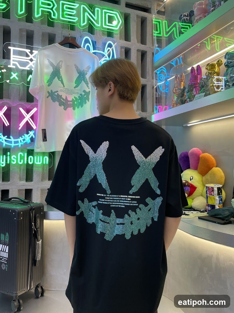 Man wearing a black t-shirt with a smiley face graphic