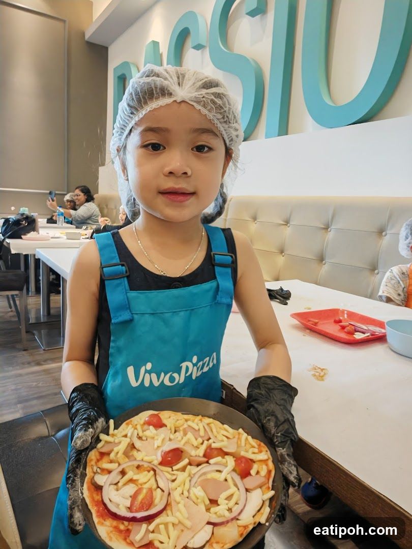 Young girl holding a pizza