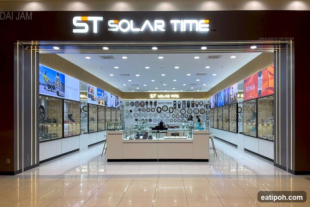 The exterior of a watch store named ST Solar Time. The store has a large illuminated sign above the entrance. Inside, display cases showcase watches and accessories, and a wall is decorated with numerous clocks.