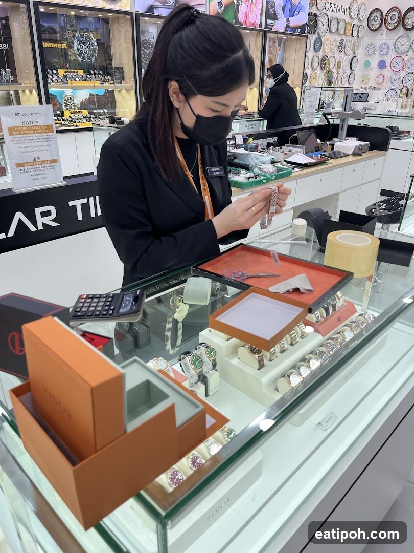 Sales associate assisting customer with watches