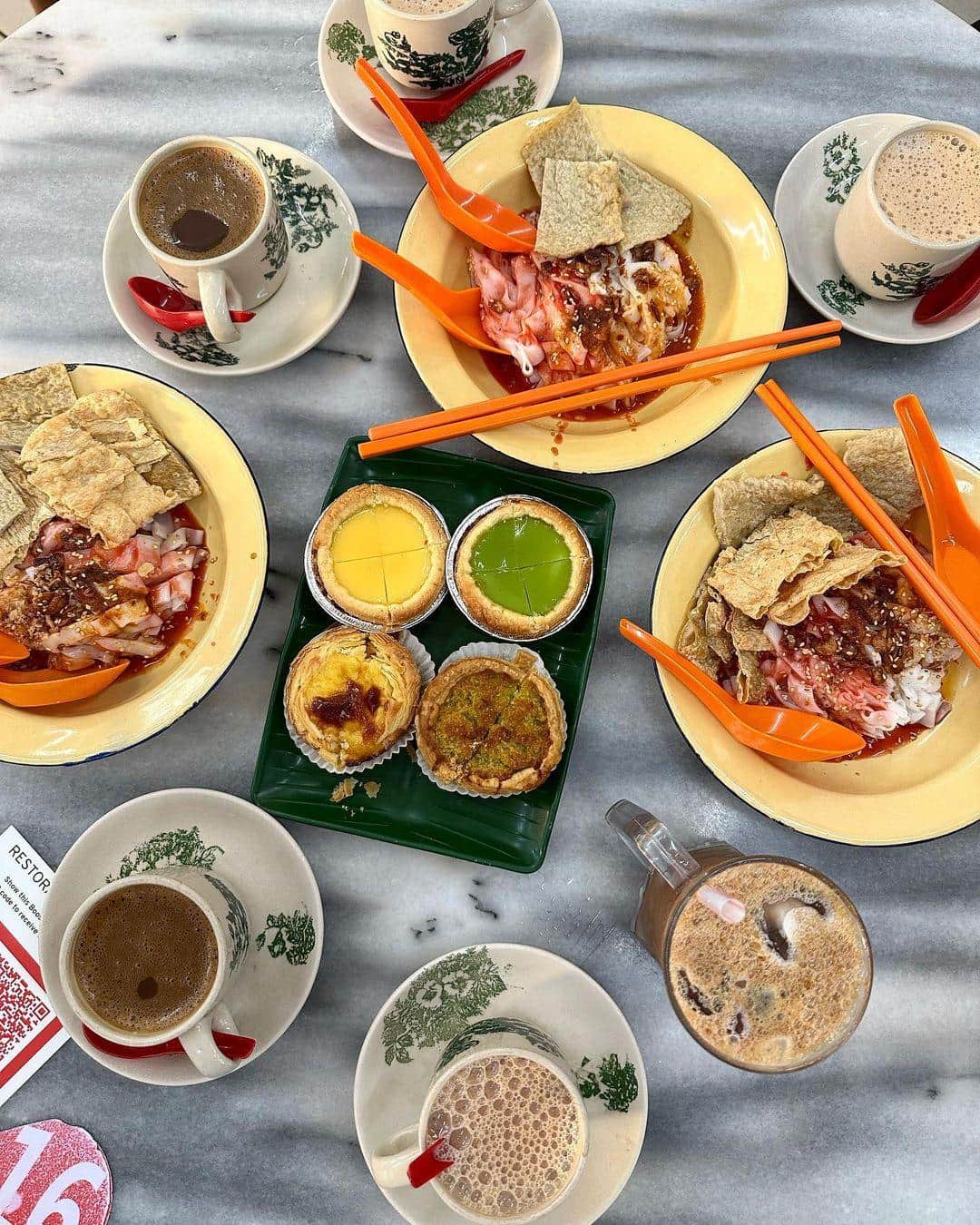A traditional Ipoh kopitiam breakfast setting with coffee and local dishes