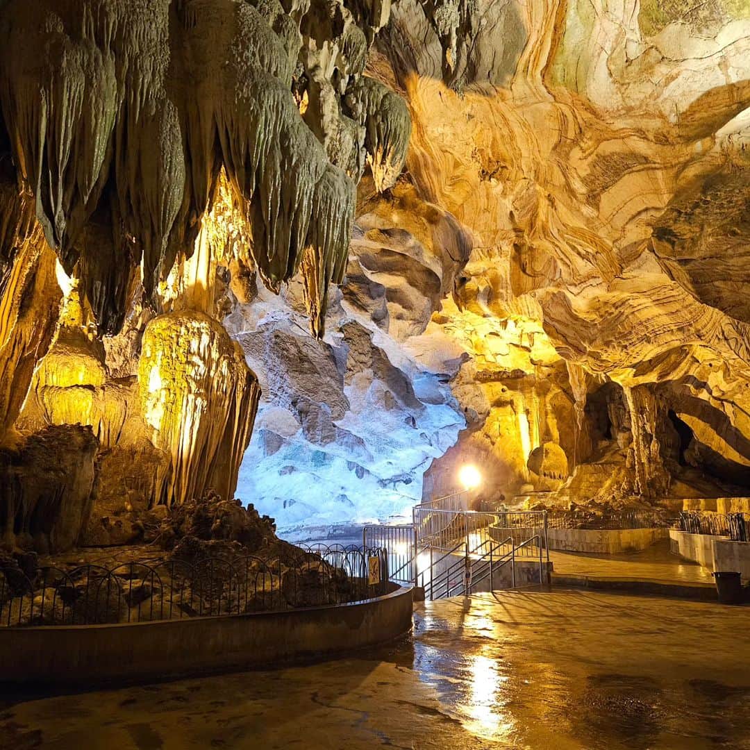 Interior of a cave temple with Buddha statues and natural rock formations