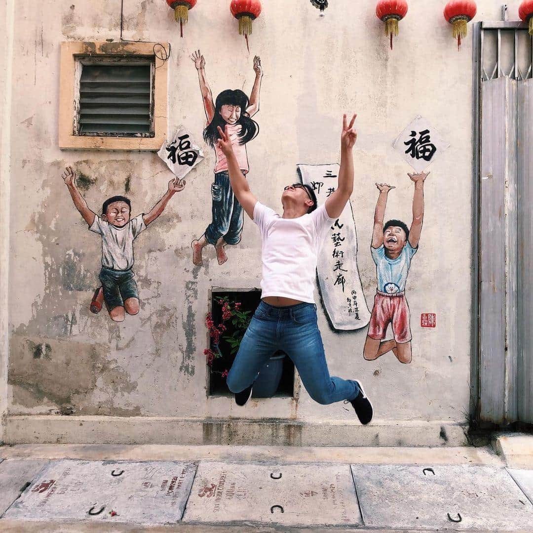 Street art murals on the walls of heritage shophouses near Concubine Lane