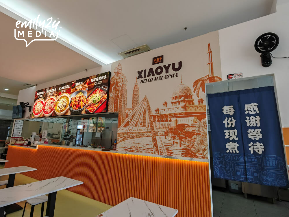 XiaoYuHao Ipoh Octagon interior with glass-panel kitchen and dining area at Wisma Octagon